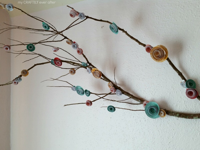 diy rolled paper flowers on a branch
