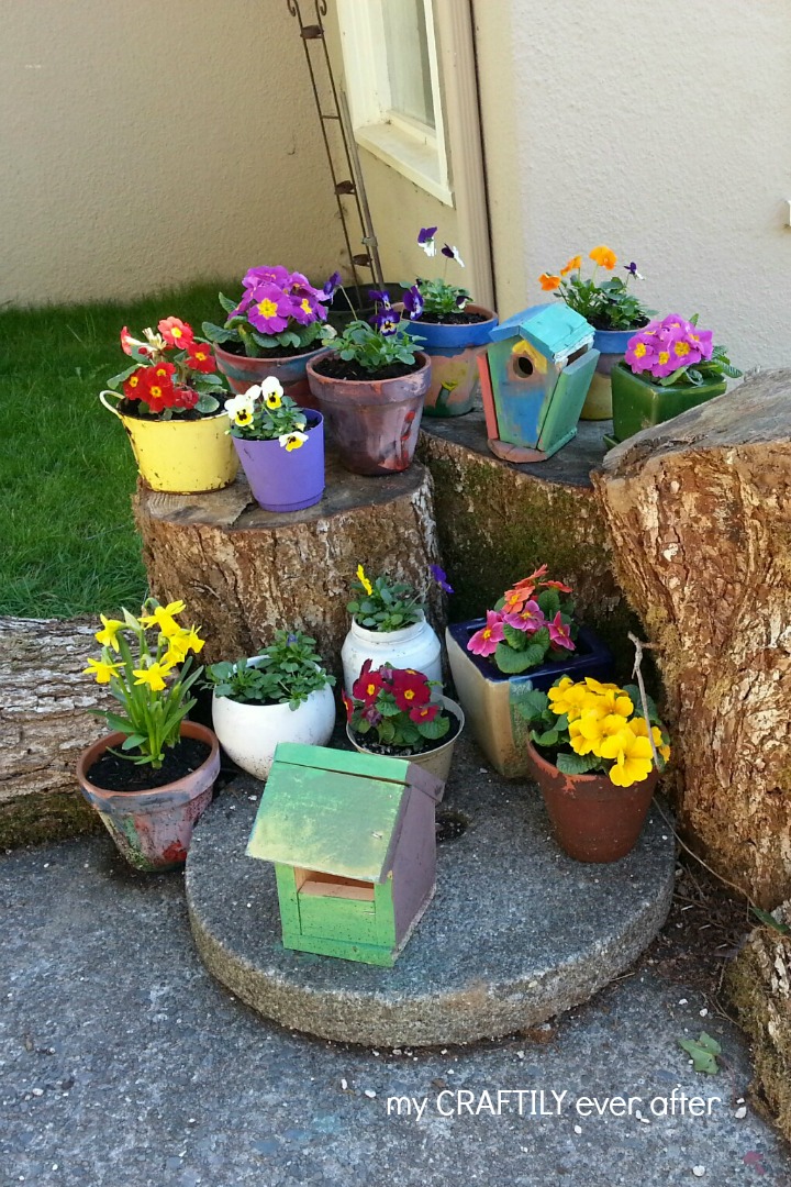 colorful flower garden with tree stumps