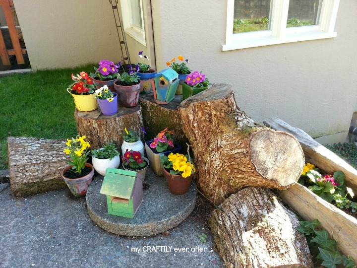 tree stump garden with colorful pots